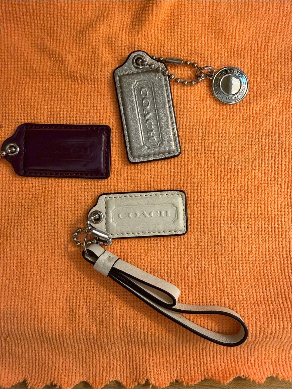 Coach Trio of Leather and Patent Tag Charms with Cream Wristlet